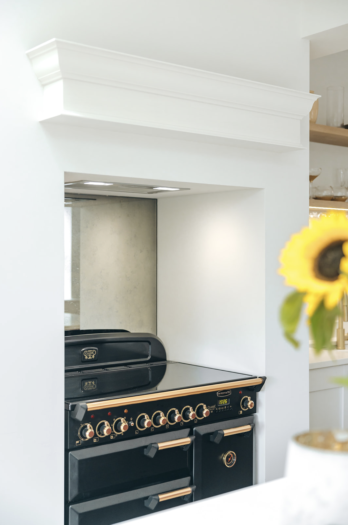 Grand period room with tall sash windows, ceiling rose and a new kitchen designed into it