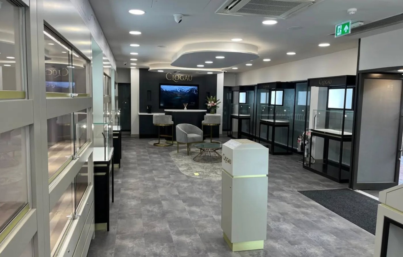 Clogau store interior with illuminated wall cases and a central consultation hub