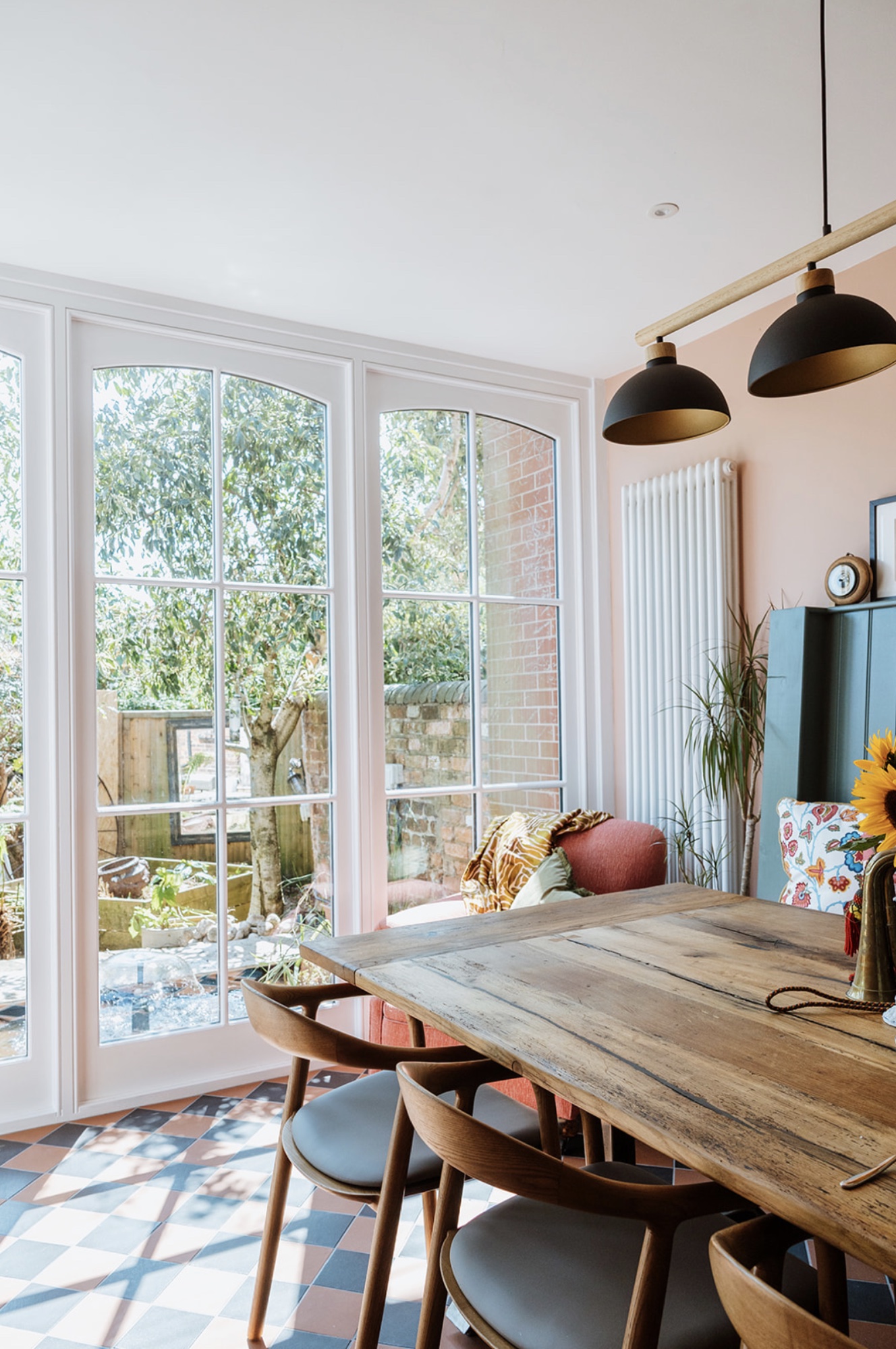 Oak Street dining table and checkerboard floor beside garden doors